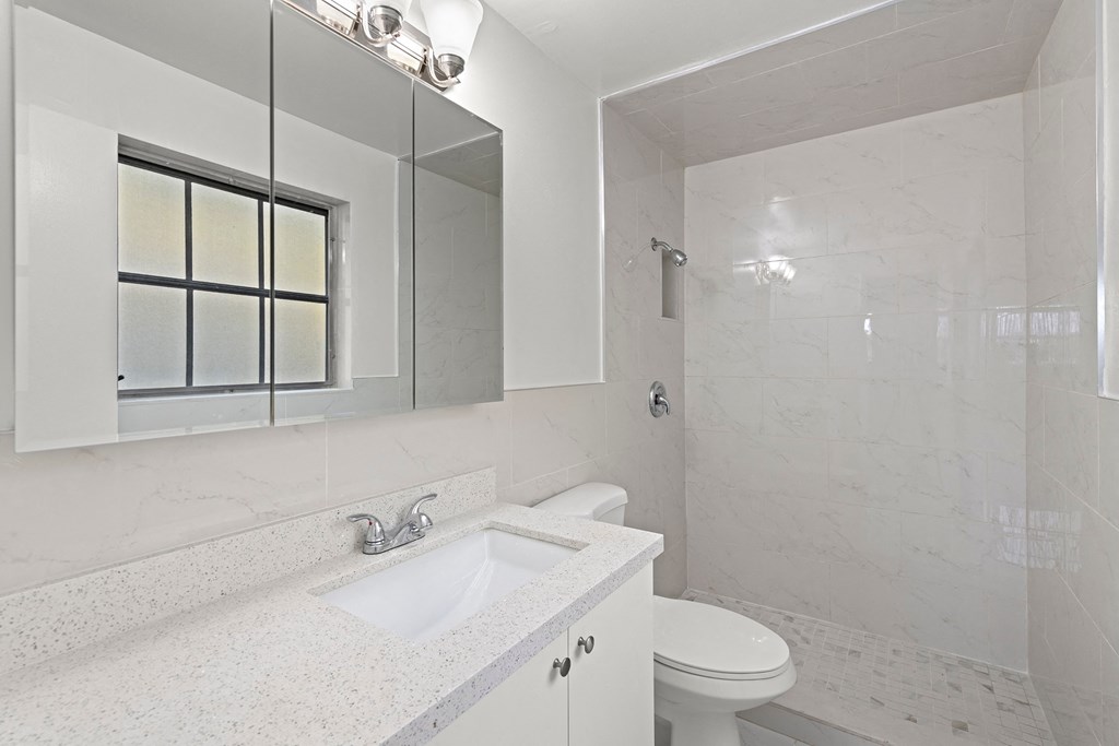 a bathroom with a sink toilet and a mirror