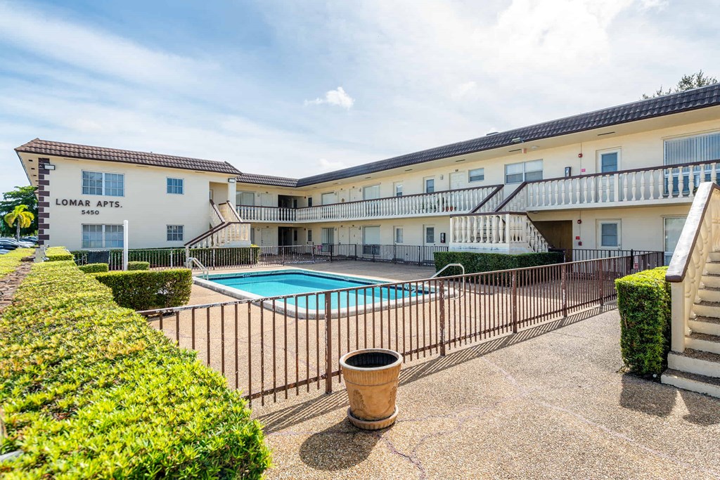 a view of the pool of a hotel with a swimming pool