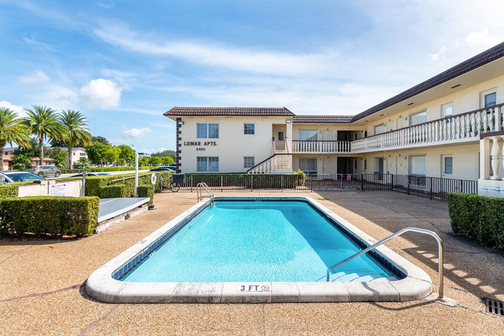 a swimming pool in front of a building with a pool