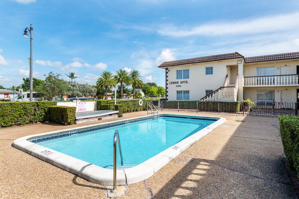 a swimming pool in front of a building with a pool