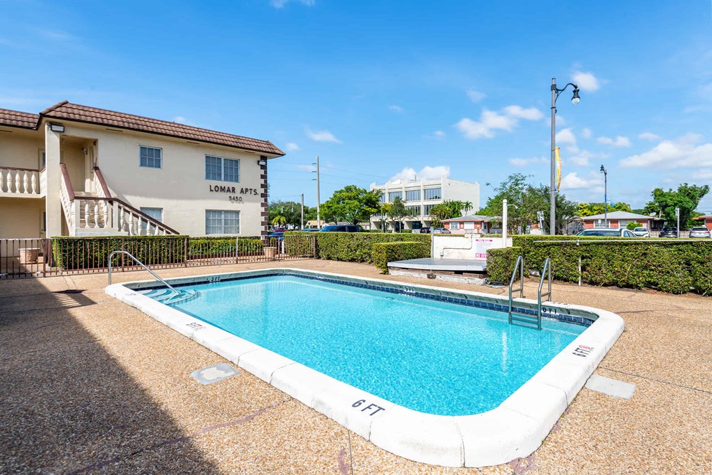 a swimming pool with a building in the background