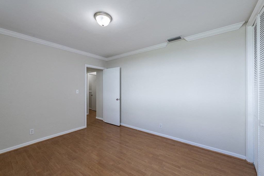 a living room with a wood floor and white walls