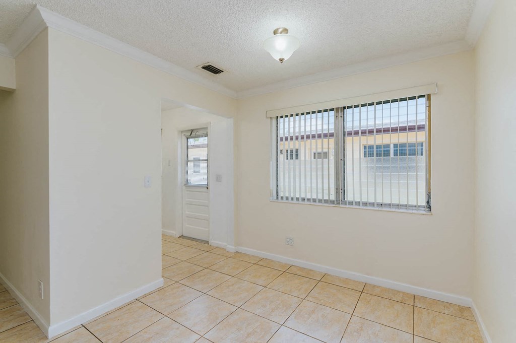 a room with a large window and a tiled floor