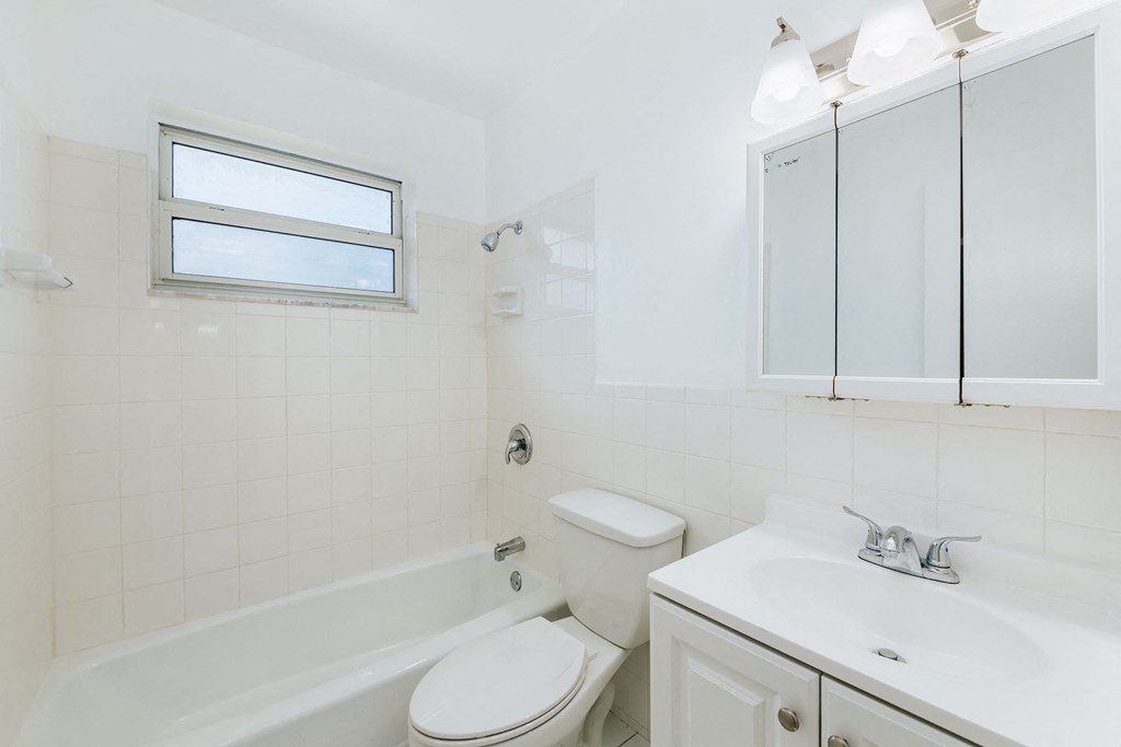 a bathroom with a sink toilet and a bath tub