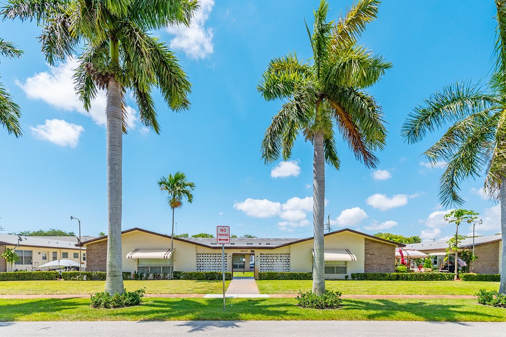 a building with palm trees in front of it