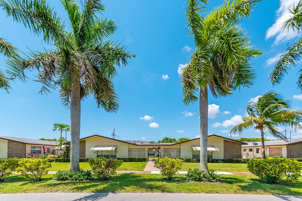 a house with palm trees in front of it