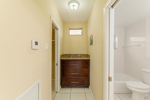 A bathroom with a toilet, sink, and window.