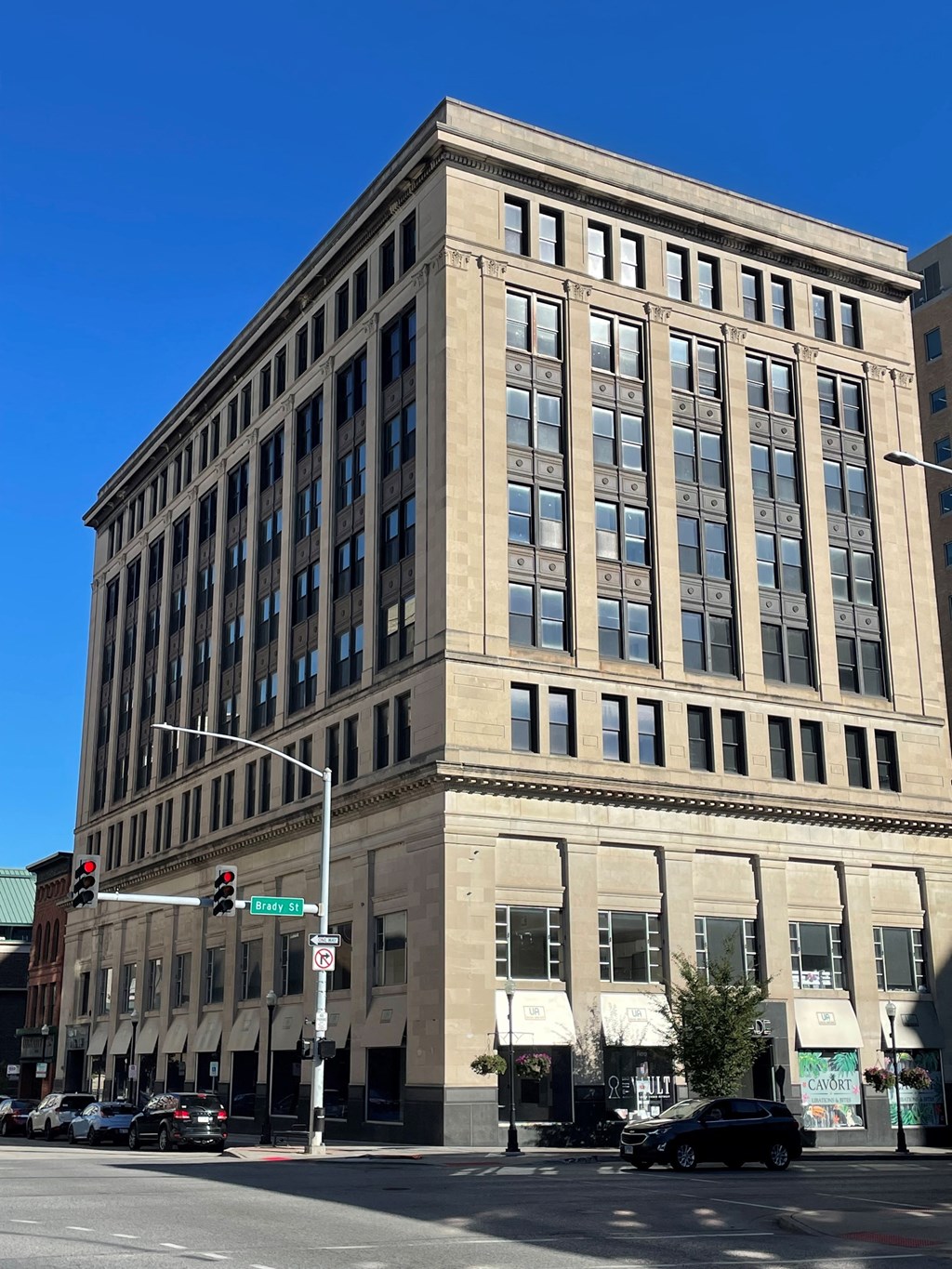a tall building on the corner of a city street