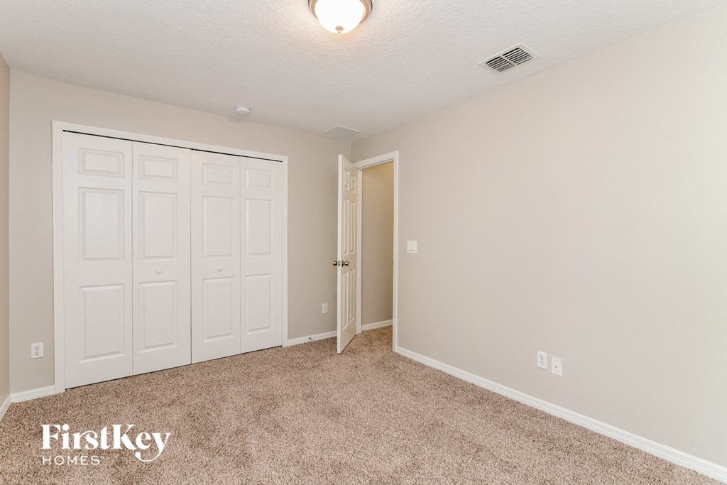 a bedroom with two closets and a door to a closet