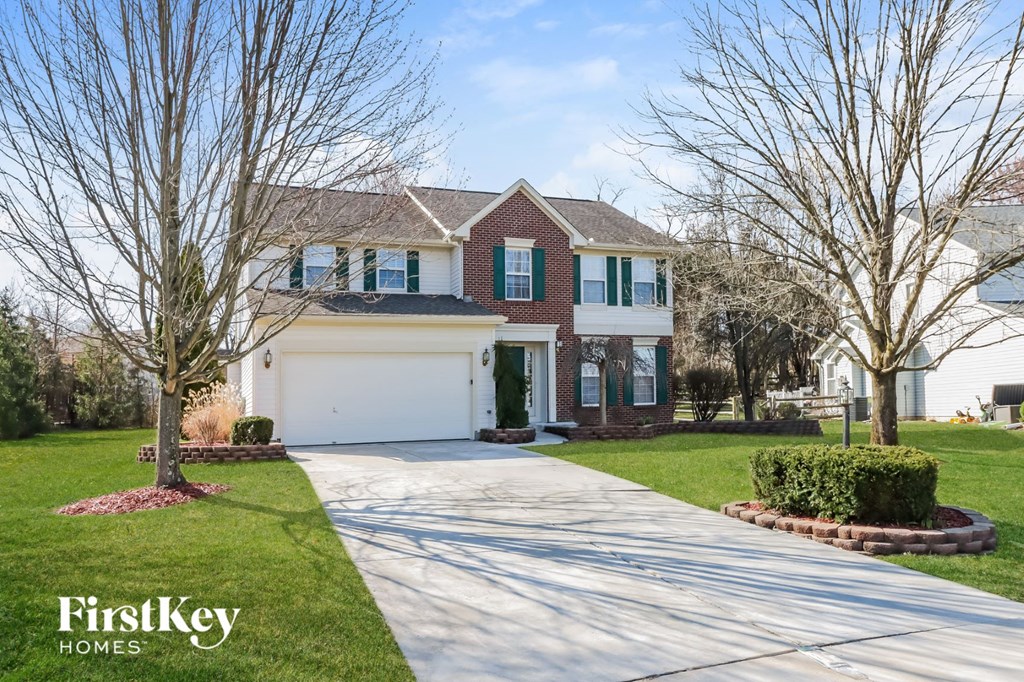 a large house with a driveway and a white garage door