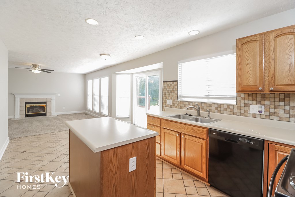 a kitchen with wooden cabinets and a white counter top