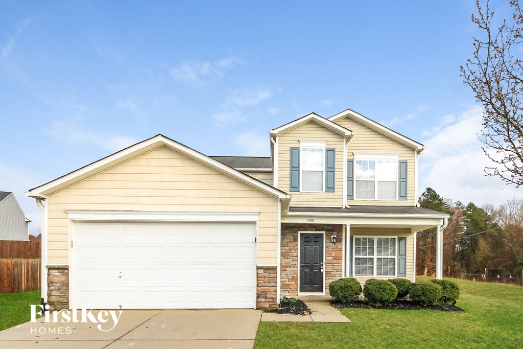 a yellow house with a white garage door