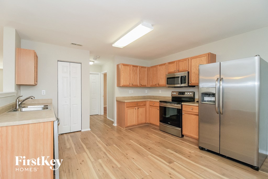 a kitchen with wooden cabinets and stainless steel appliances