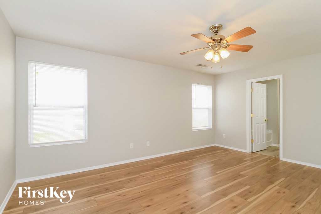 a living room with hardwood floors and a ceiling fan