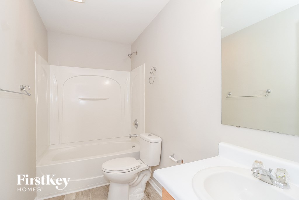a bathroom with a sink toilet and a tub