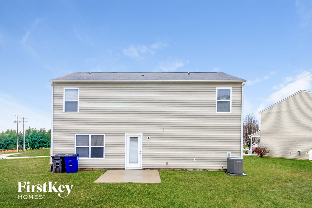 the exterior of a small house with a yard and grass
