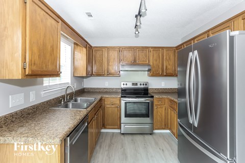 A kitchen with wooden cabinets and stainless steel appliances.