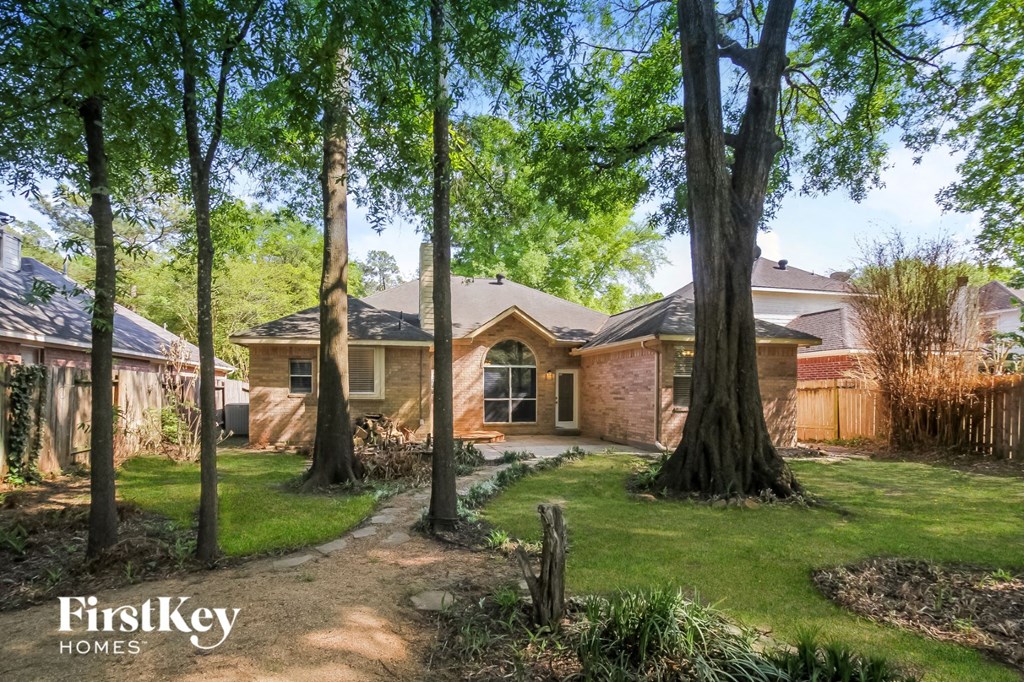 the front of a house with trees in the yard