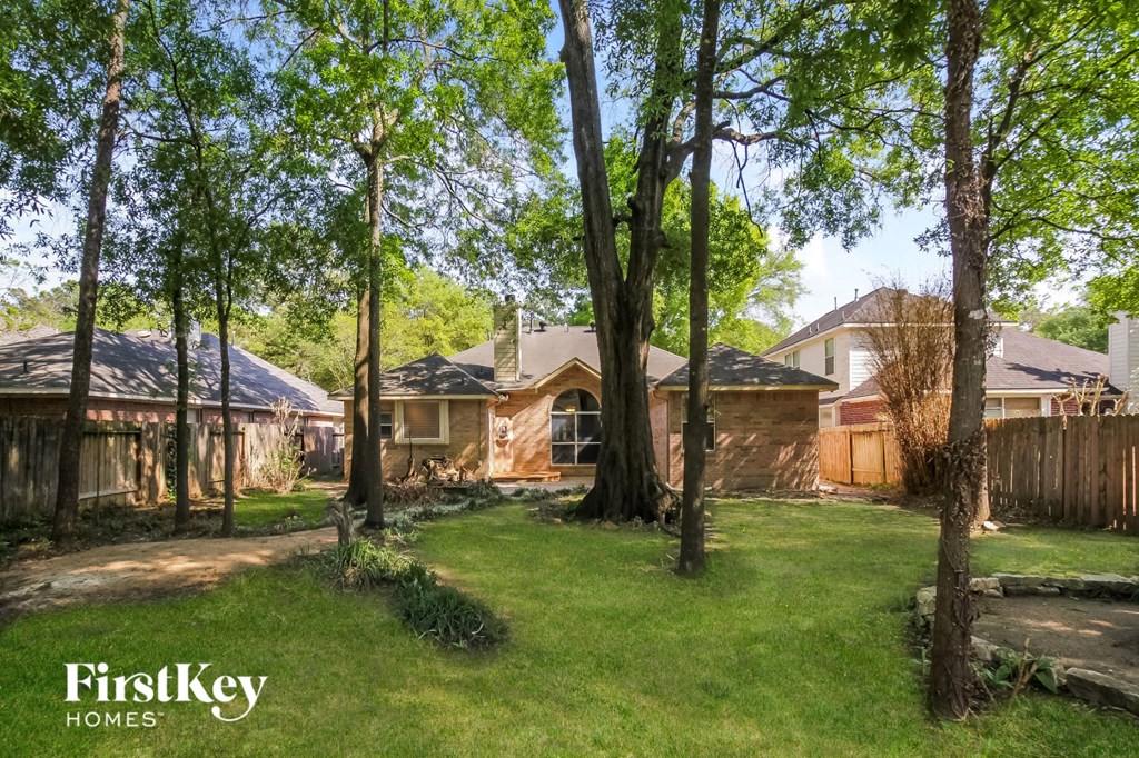 a backyard with trees and a house