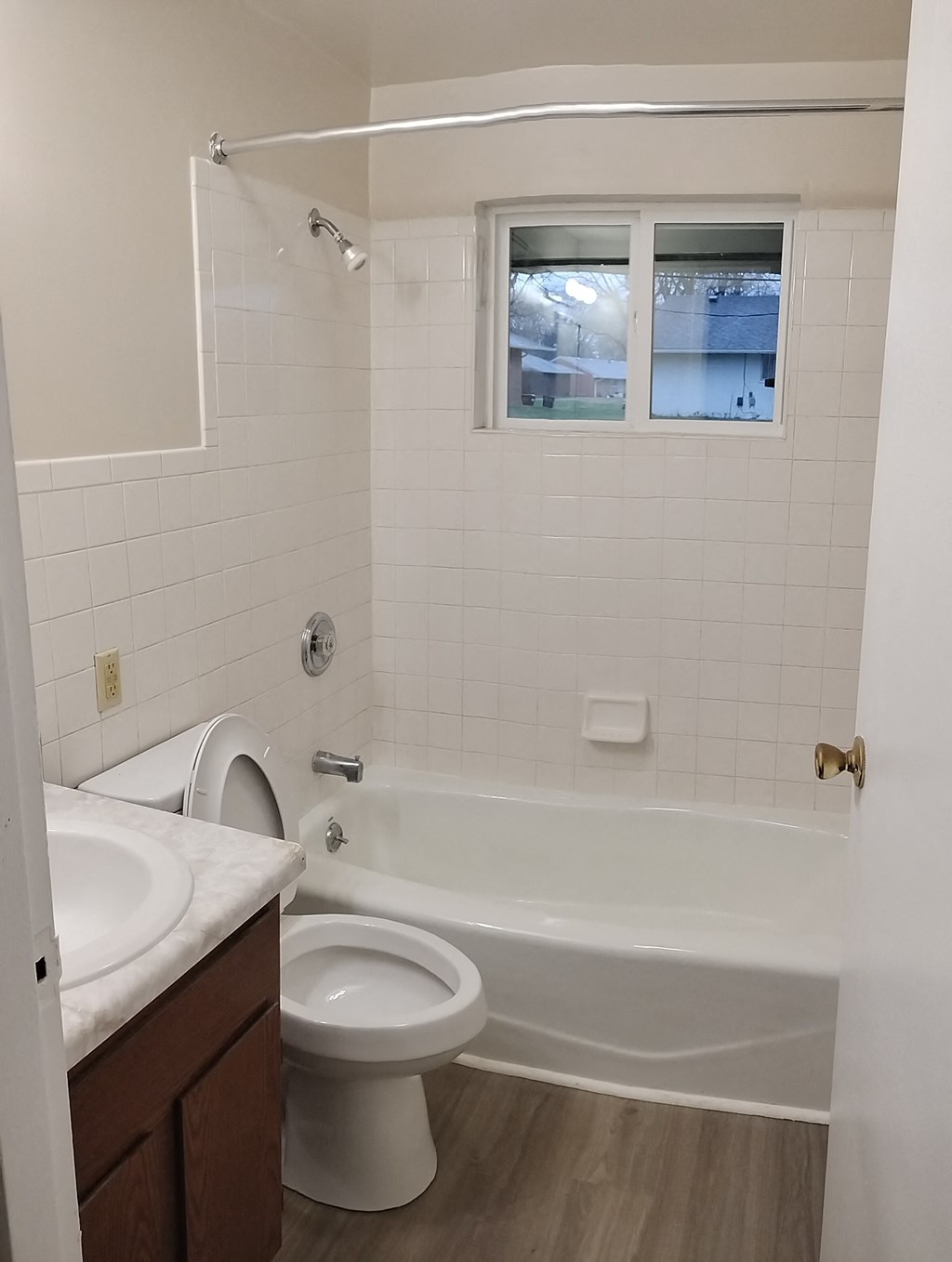 a bathroom with a toilet and a tub and a sink