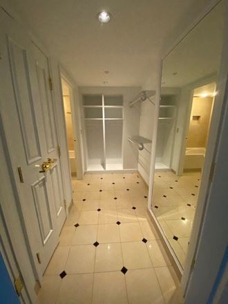 a bathroom with a tiled floor and a closet
