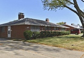 a house with a red car parked in front of it