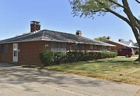 a house with a red car parked in front of it