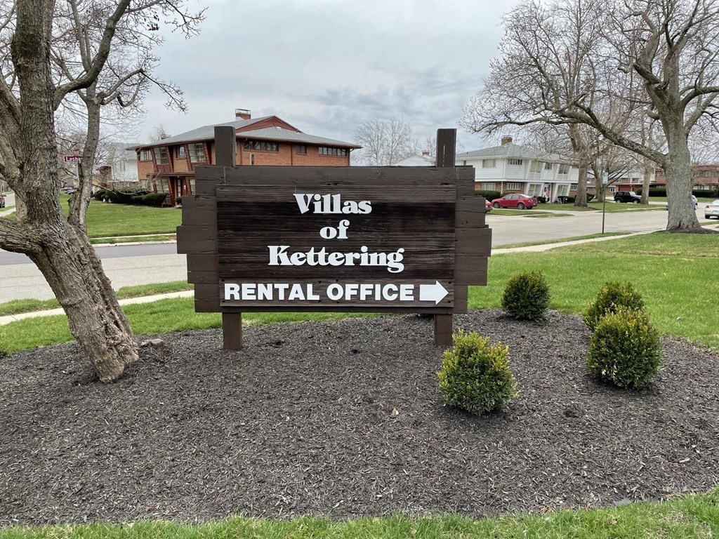 a sign for the villas of??tering rental office in front of a
