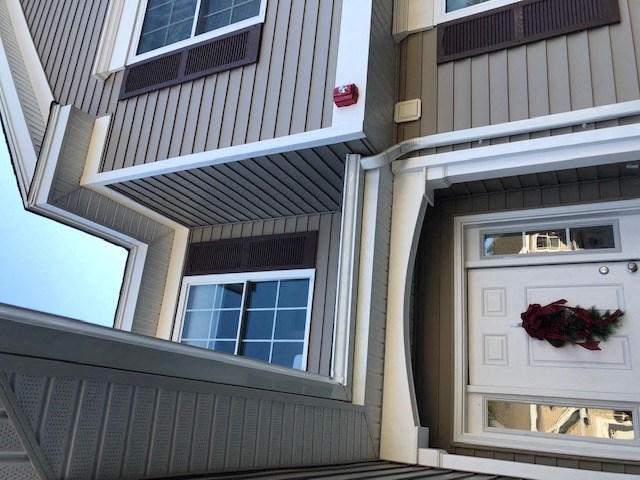 a house with a white door and a wreath on it