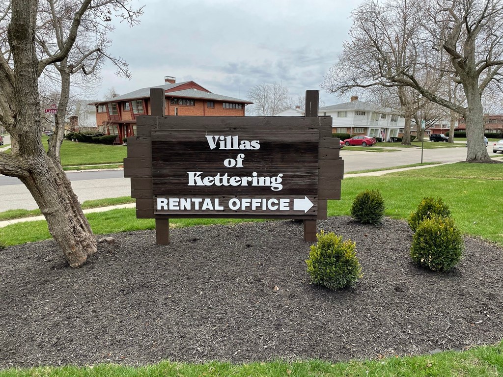 a sign for the villas of kettling rental office in front of a