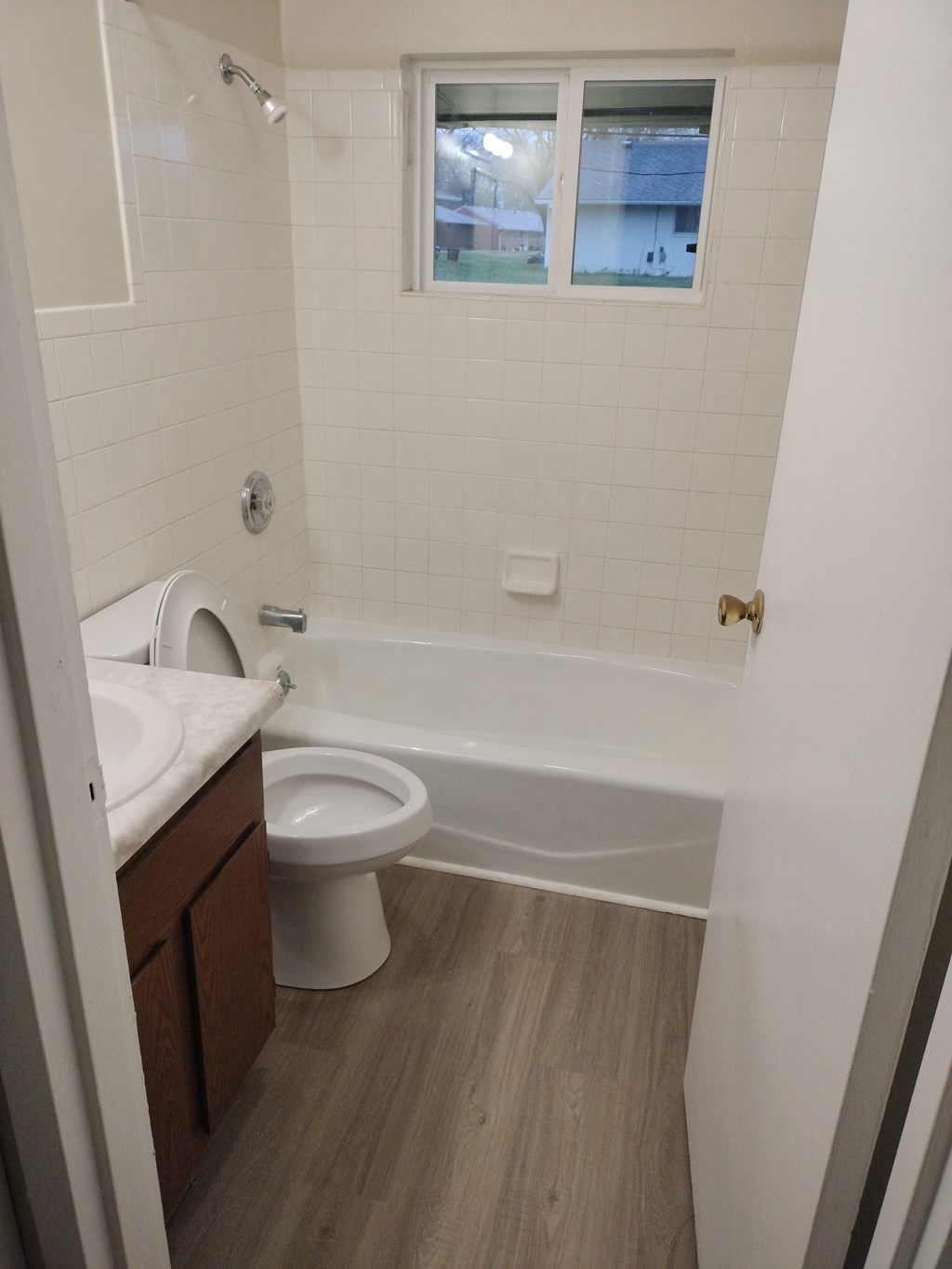 an empty bathroom with a toilet and a bath tub
