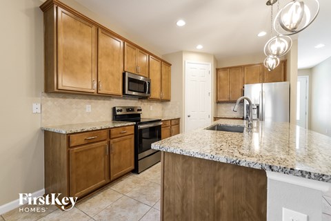 A kitchen with wooden cabinets and granite countertops.