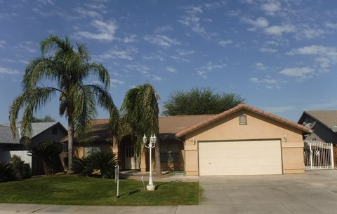 a house with palm trees in front of it