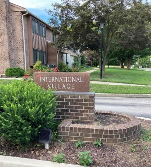 a sign for the international village in front of a building