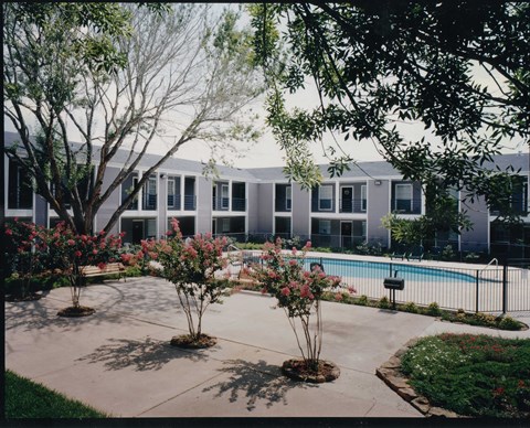 A building with a pool in front of it.