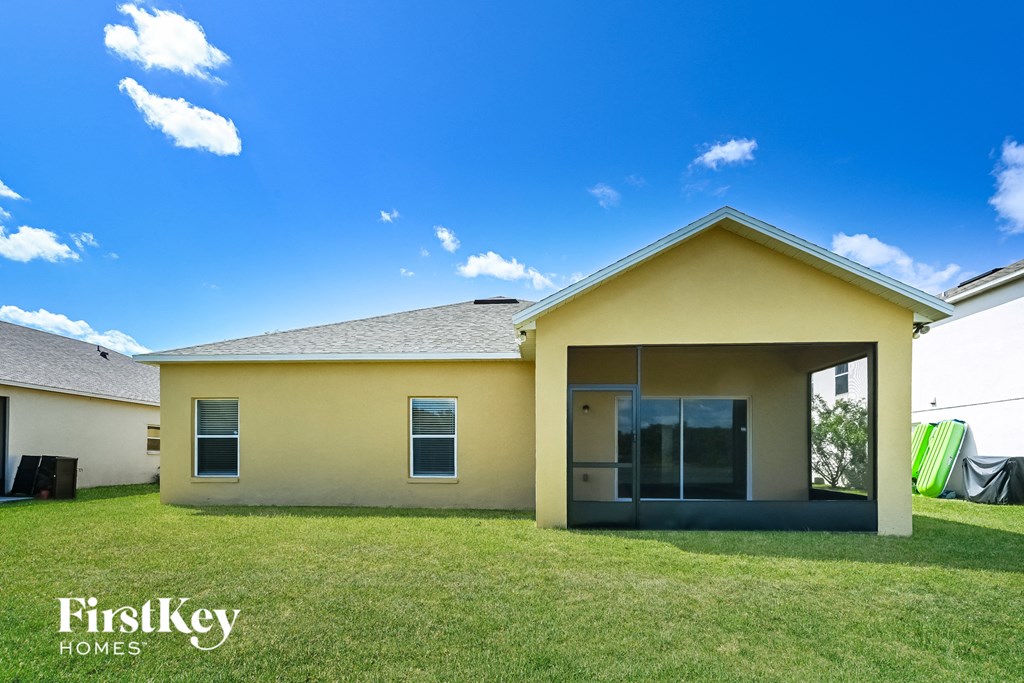 A yellow house with a glass door and a window is shown.