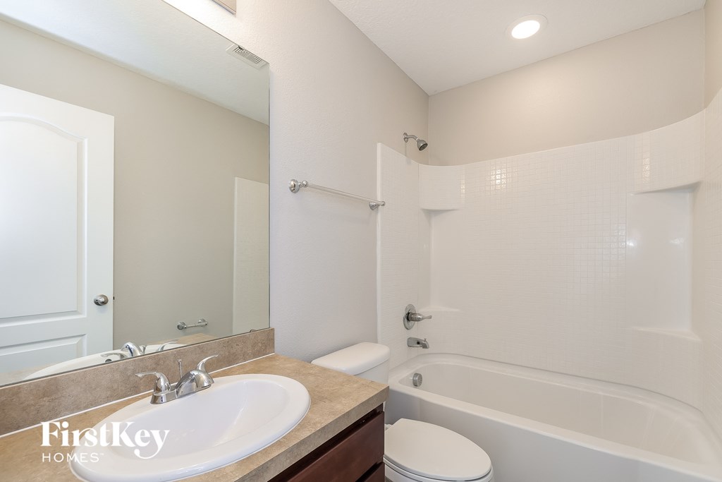 a bathroom with a sink and a tub and a toilet