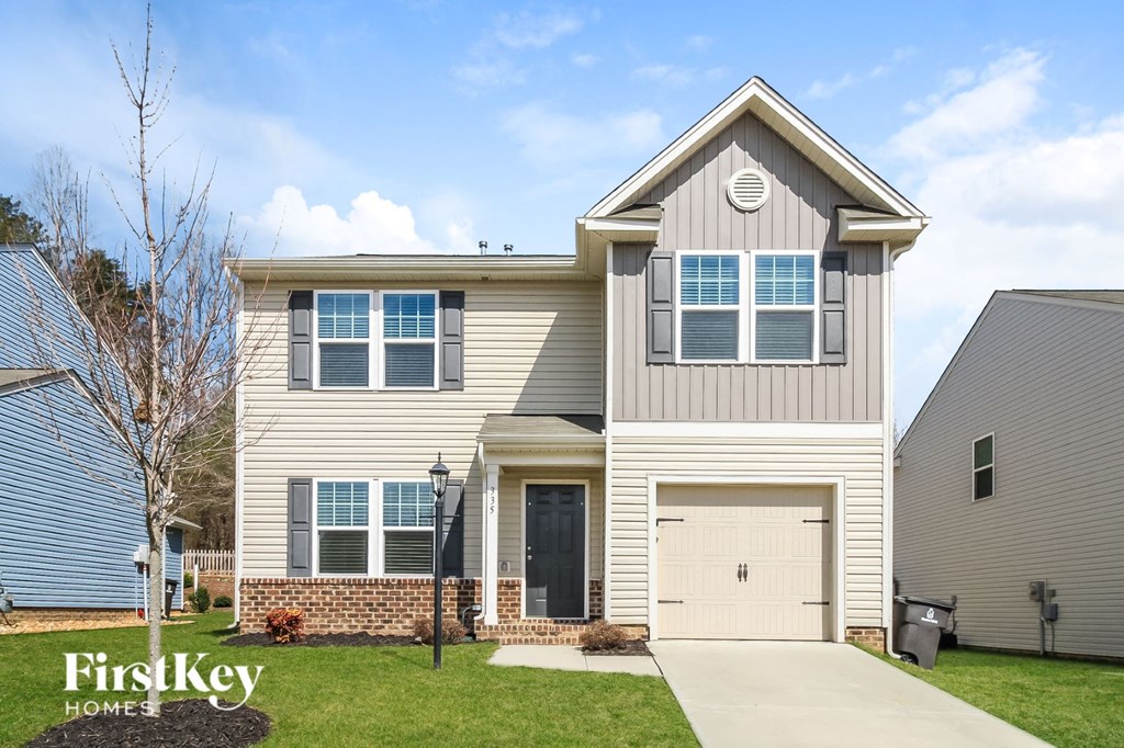 a beige house with a white garage door
