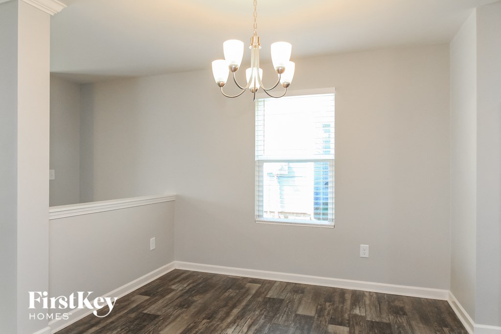 a bedroom with a window and a chandelier