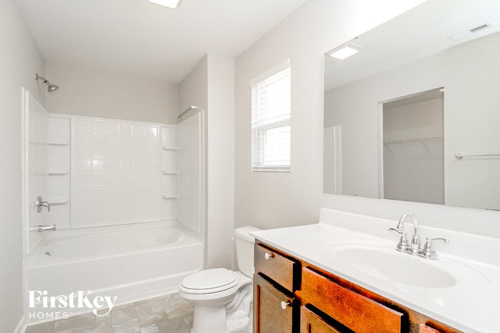a bathroom with a sink toilet and a tub