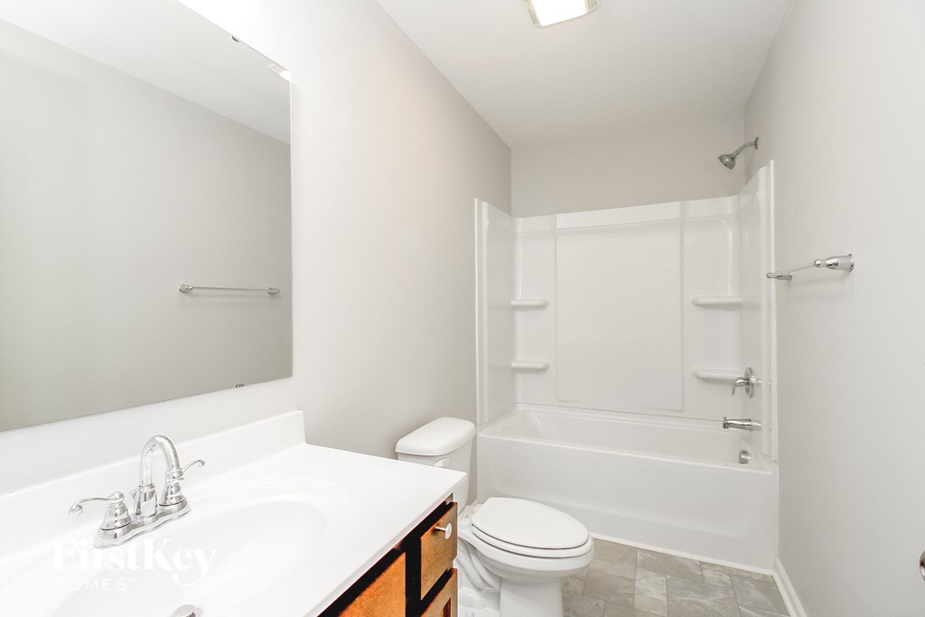 a bathroom with a sink toilet and a shower