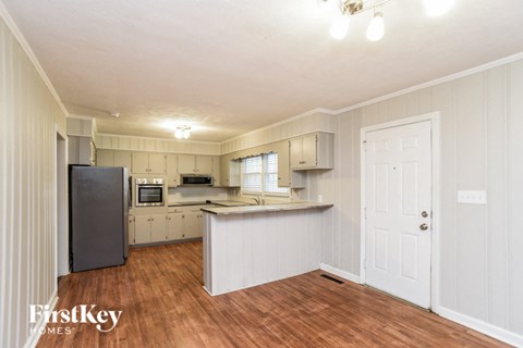 a kitchen with white cabinets and a counter top