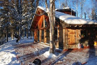 a cabin in the woods in the snow