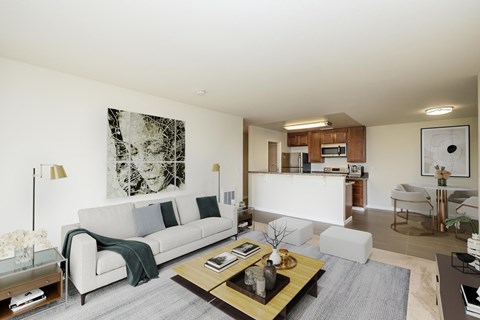A modern living room with a grey sofa and a coffee table.