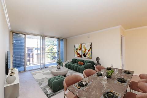A modern dining room with a glass table and chairs.