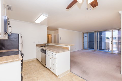 A kitchen with white appliances and a countertop.