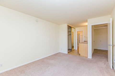 A room with a carpeted floor and white walls.