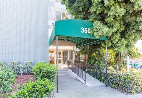 A building with a green awning and the number 350 on it.