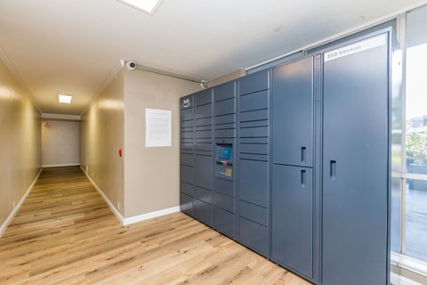 A long hallway with a wall of lockers on the right side.