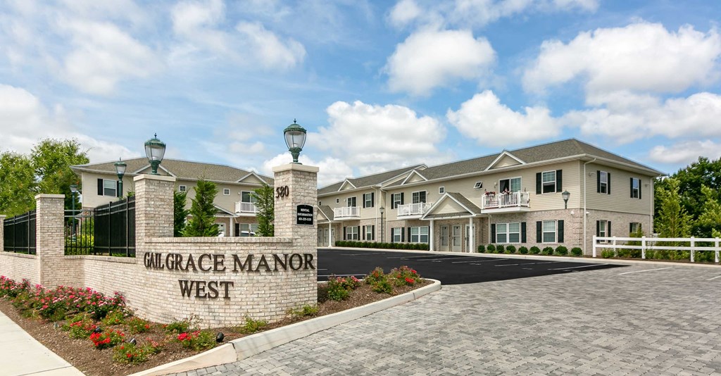 an exterior view of a large building with a sign that reads garage manor west